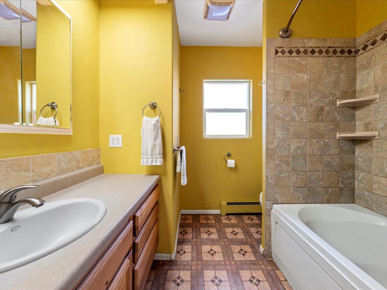 608 Bluff Street Delta, CO 81416 - Photo 29 of 42 a bathroom with a tub sink and mirror