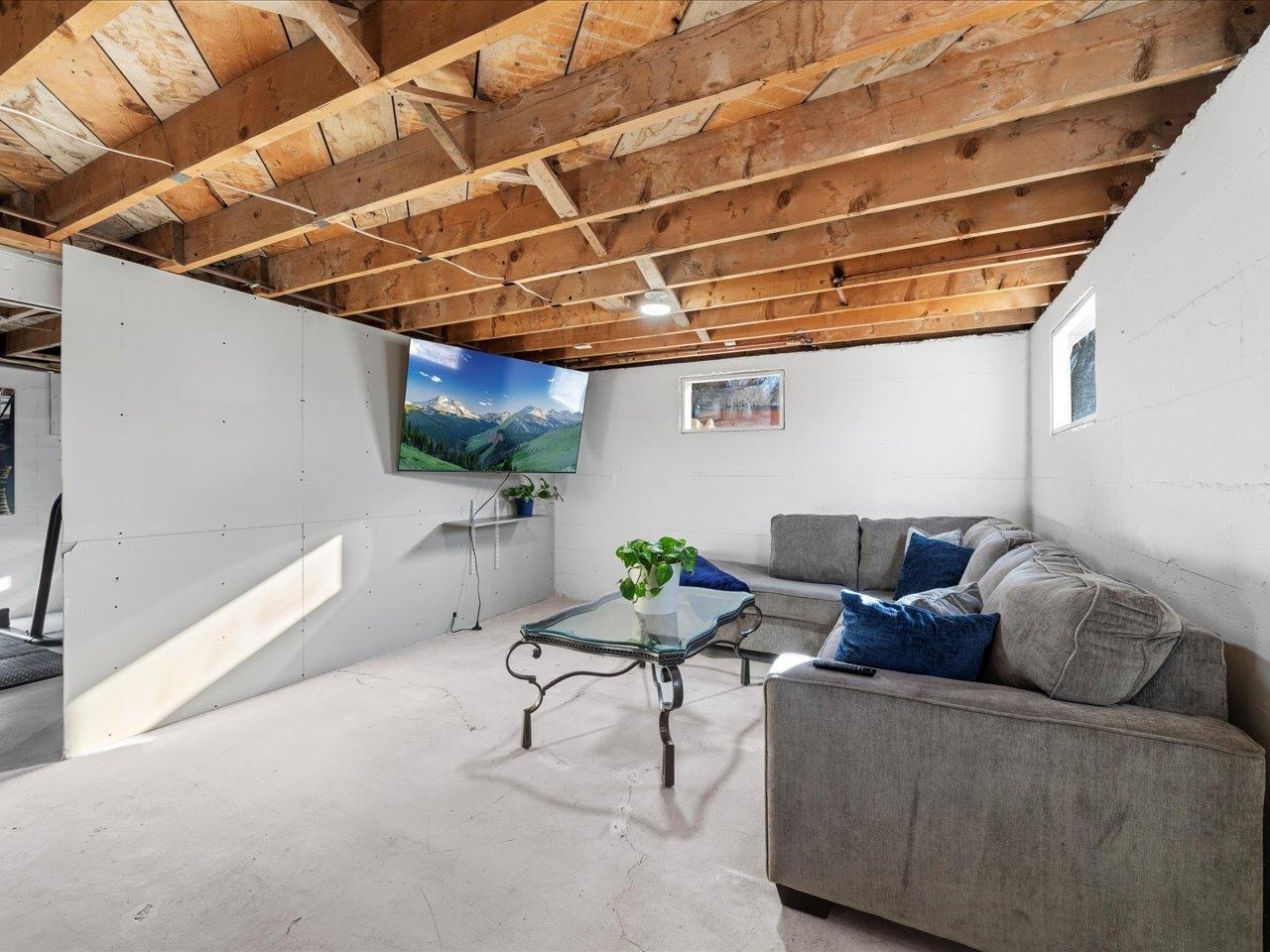 608 Bluff Street Delta, CO 81416 - Photo 32 of 42 a living room with furniture and a chandelier