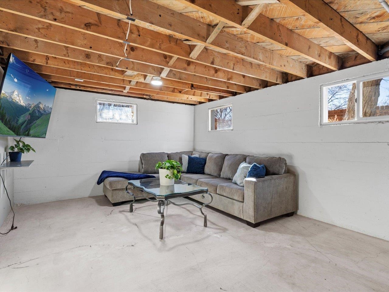 608 Bluff Street Delta, CO 81416 - Photo 34 of 42 a living room with furniture and a flat screen tv