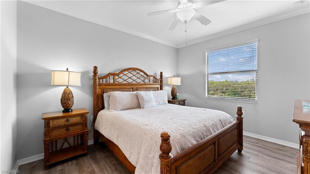 9727 Acqua Court, Unit 444 Naples, FL 34113 - Photo 13 of 25 a bedroom with a bed and a window