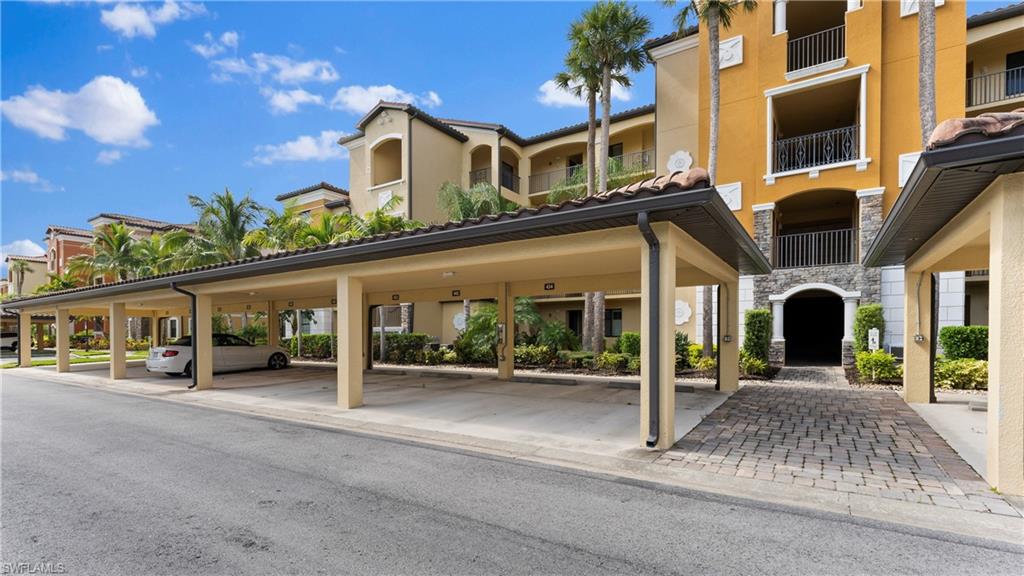 9727 Acqua Court, Unit 444 Naples, FL 34113 - Photo 23 of 25 front view of a building with a street