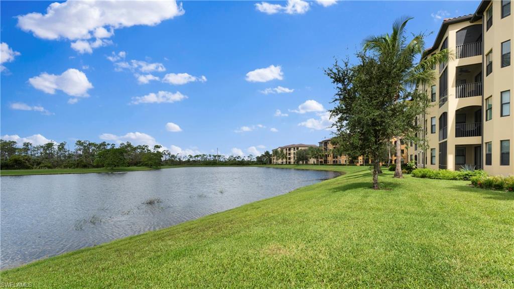 9727 Acqua Court, Unit 444 Naples, FL 34113 - Photo 24 of 25 a view of a lake with houses in back