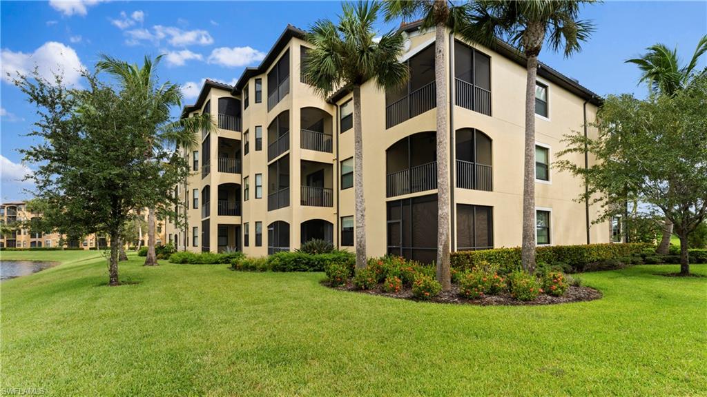 9727 Acqua Court, Unit 444 Naples, FL 34113 - Photo 25 of 25 a view of a building with a yard