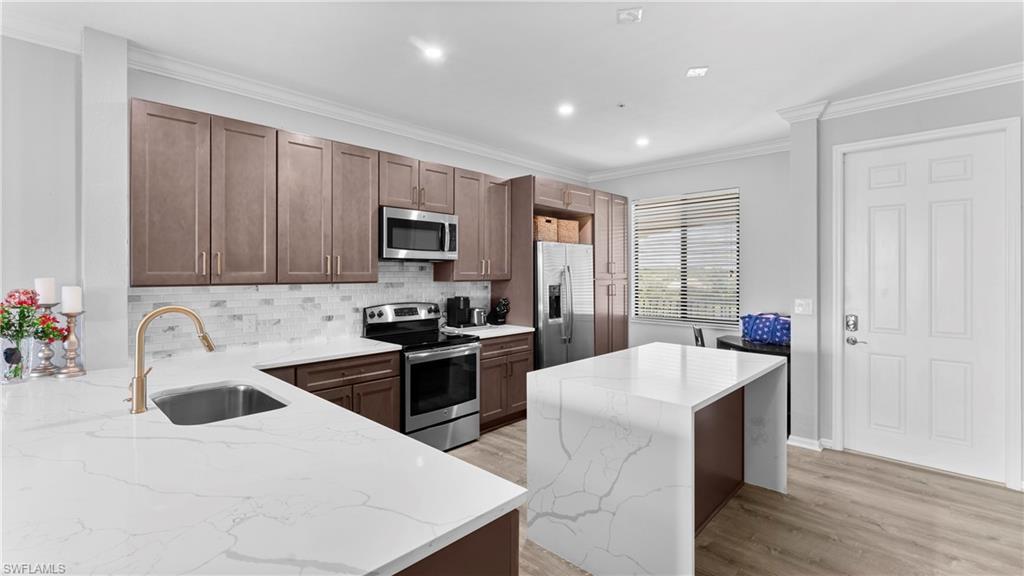 9727 Acqua Court, Unit 444 Naples, FL 34113 - Photo 3 of 25 a kitchen with granite countertop a sink stove and refrigerator