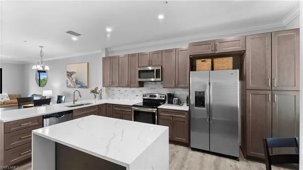 a kitchen with a refrigerator a sink a stove and microwave
