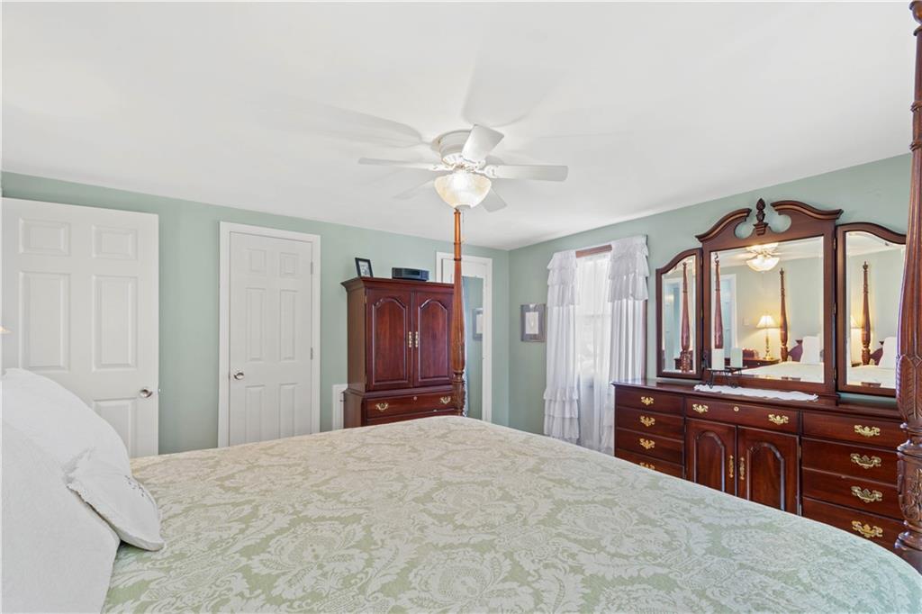 102 Conewanta Road Pittsburgh, PA 15241 - Photo 15 of 25 a bedroom with a bed and a dresser with mirror
