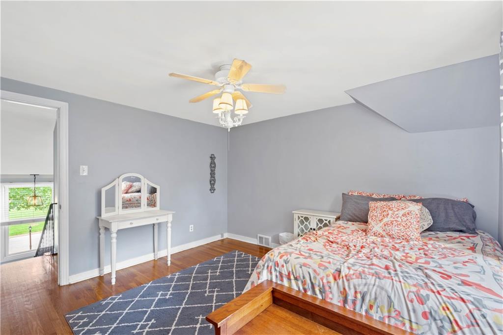 102 Conewanta Road Pittsburgh, PA 15241 - Photo 16 of 25 a bedroom with a bed and a chandelier