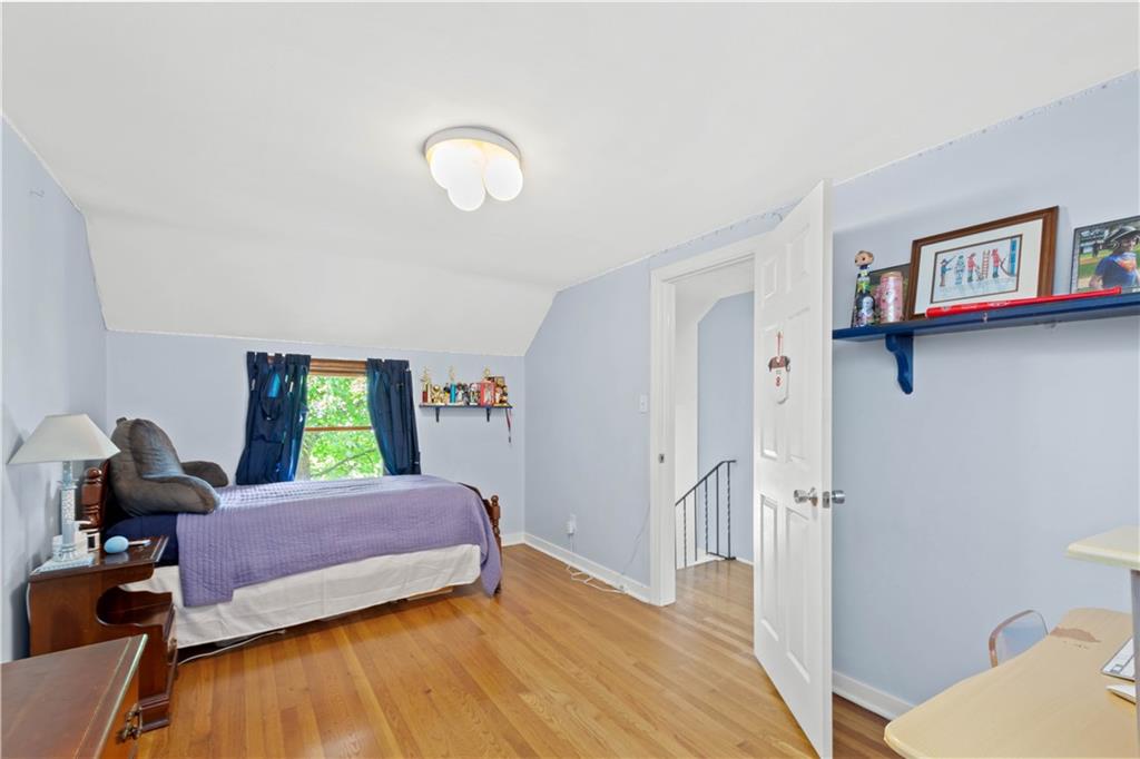 102 Conewanta Road Pittsburgh, PA 15241 - Photo 18 of 25 a bedroom with a bed and wooden floor