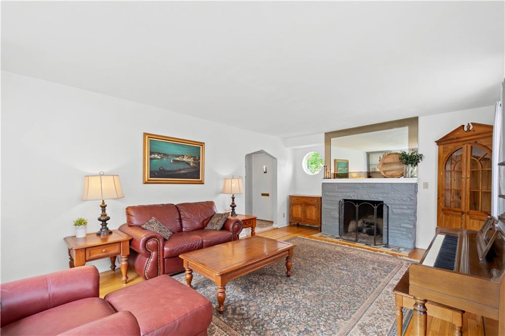102 Conewanta Road Pittsburgh, PA 15241 - Photo 6 of 25 a living room with furniture a flat screen tv and a fireplace