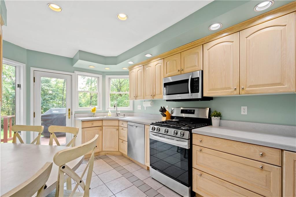 102 Conewanta Road Pittsburgh, PA 15241 - Photo 8 of 25 a kitchen with granite countertop a stove top oven microwave and cabinets