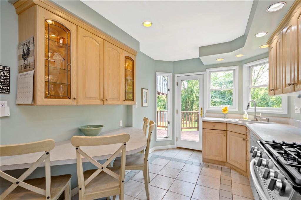 102 Conewanta Road Pittsburgh, PA 15241 - Photo 9 of 25 a kitchen with a stove a sink and chairs