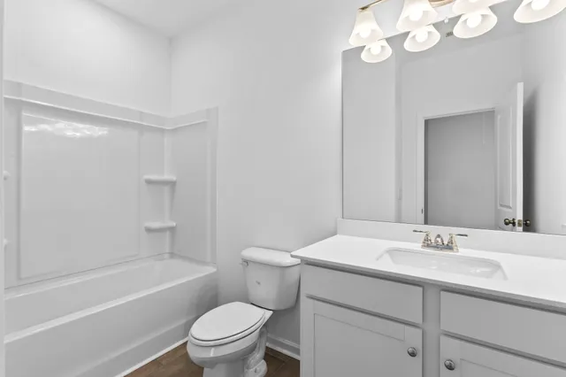 a white bath tub sitting next to a white toilet