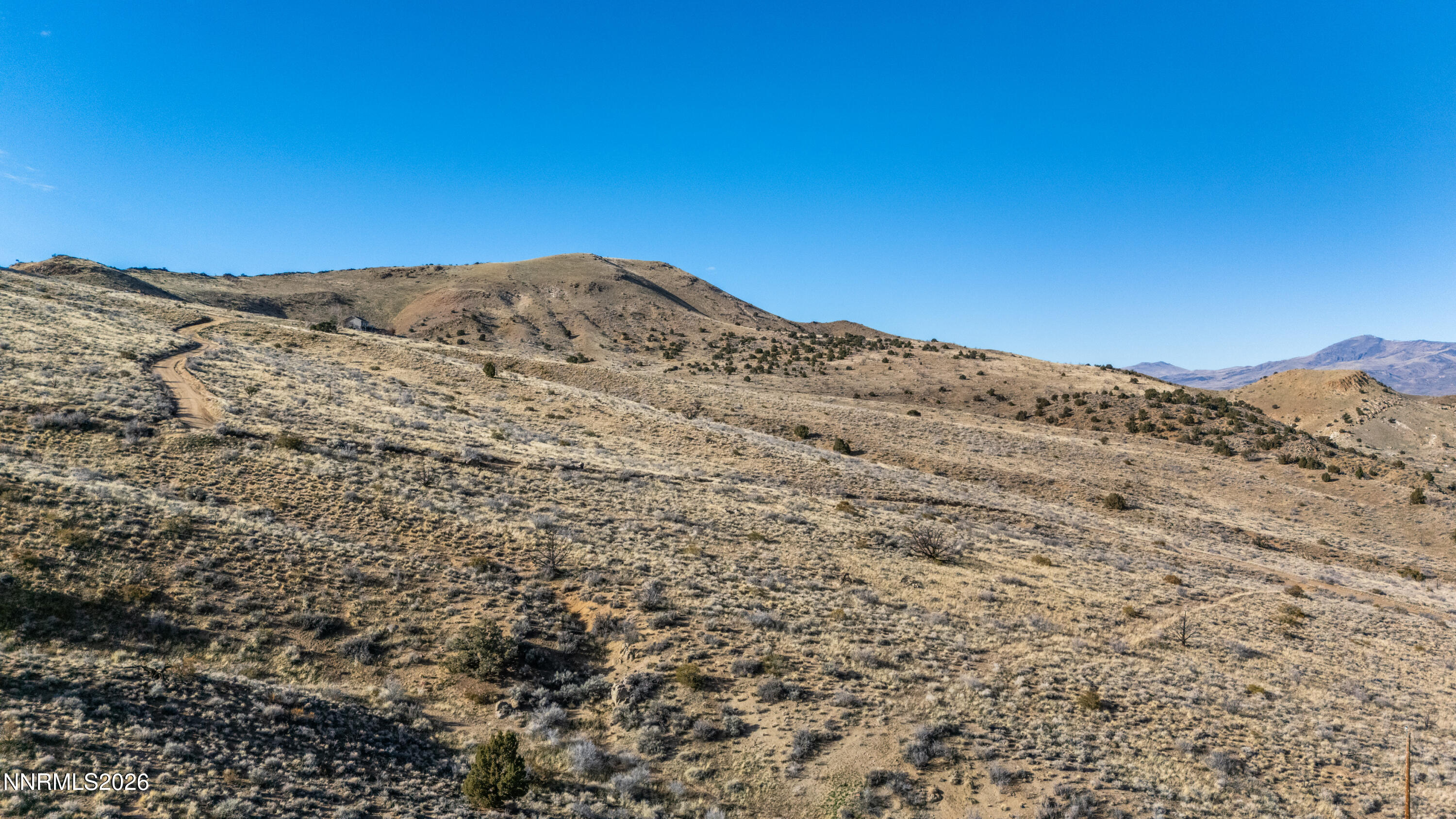 0 Ironwood Road Reno, NV 89510 - Photo 32 of 40 a view of a mountain range in a cloudy sky