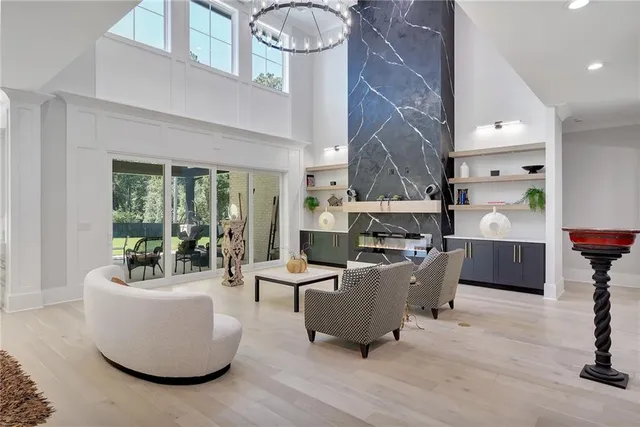 a dining room with furniture a chandelier and window