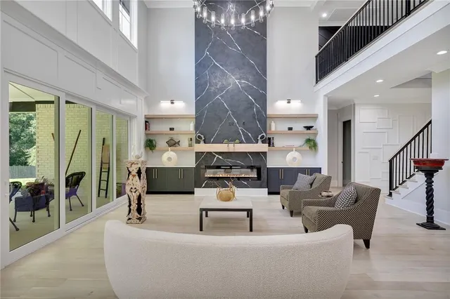 a spacious bedroom with a bed and a chandelier