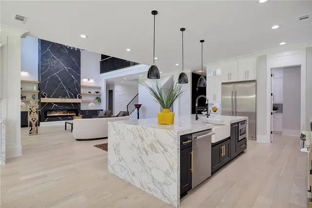 a spacious bathroom with a granite countertop sink a toilet a mirror and shower