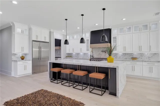a kitchen with a refrigerator and a stove