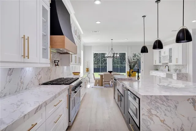 a kitchen with a sink dishwasher a refrigerator and cabinets