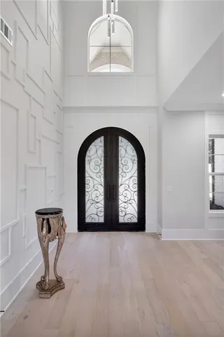 a living room with furniture a fireplace and a dining table with wooden floor