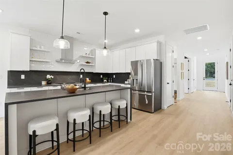 a kitchen with granite countertop a sink stainless steel appliances and cabinets