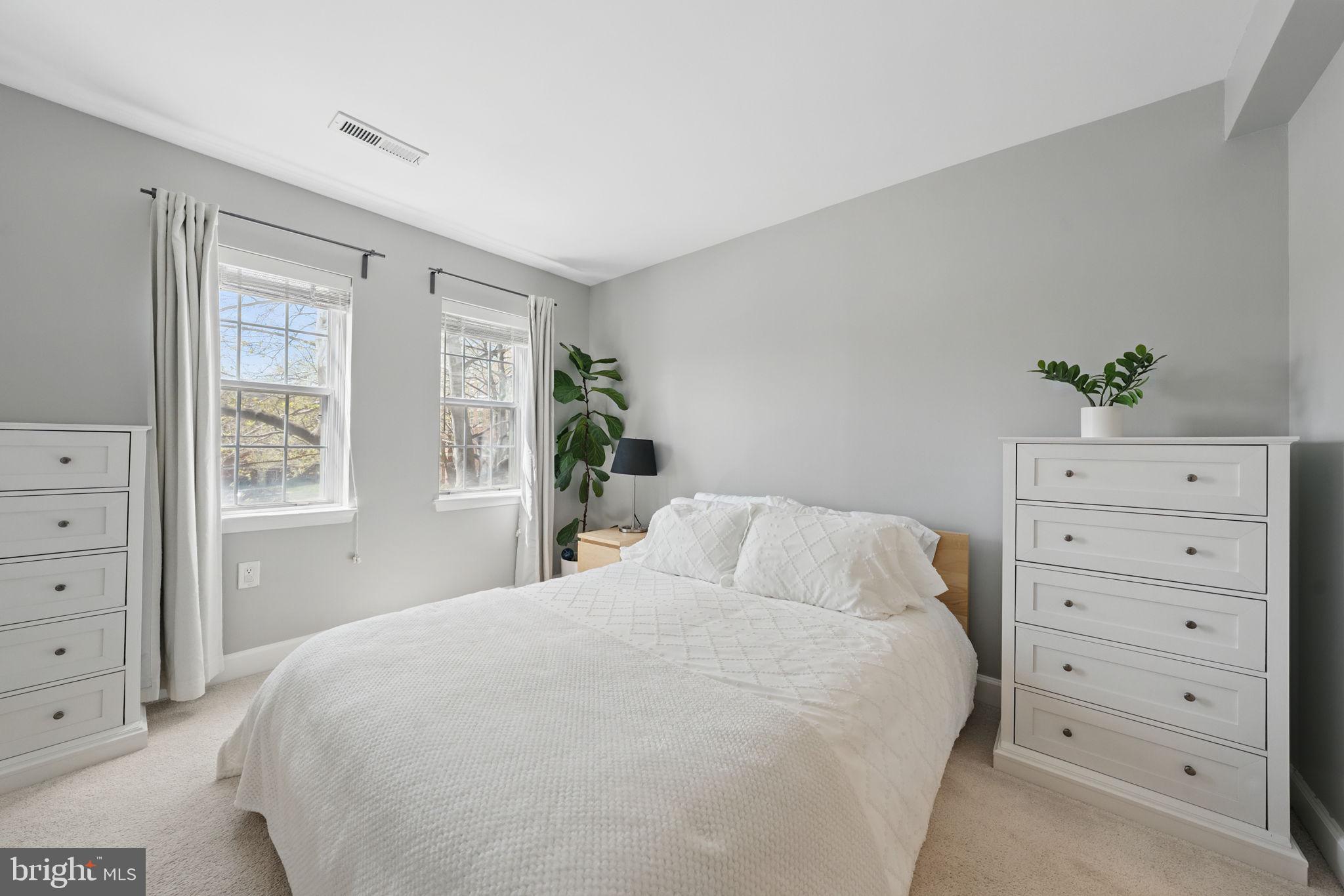 3611 38th Street Northwest, Unit 209 Washington, DC 20016 - Photo 12 of 30 a bedroom with a bed and a dresser