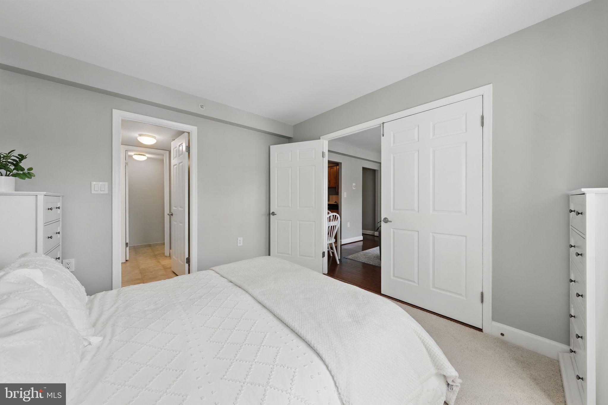 3611 38th Street Northwest, Unit 209 Washington, DC 20016 - Photo 13 of 30 a bedroom with a bed and a mirror