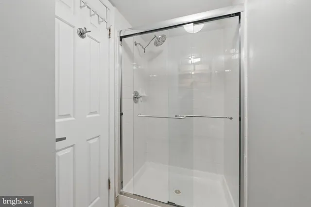 a bathroom with a glass shower door