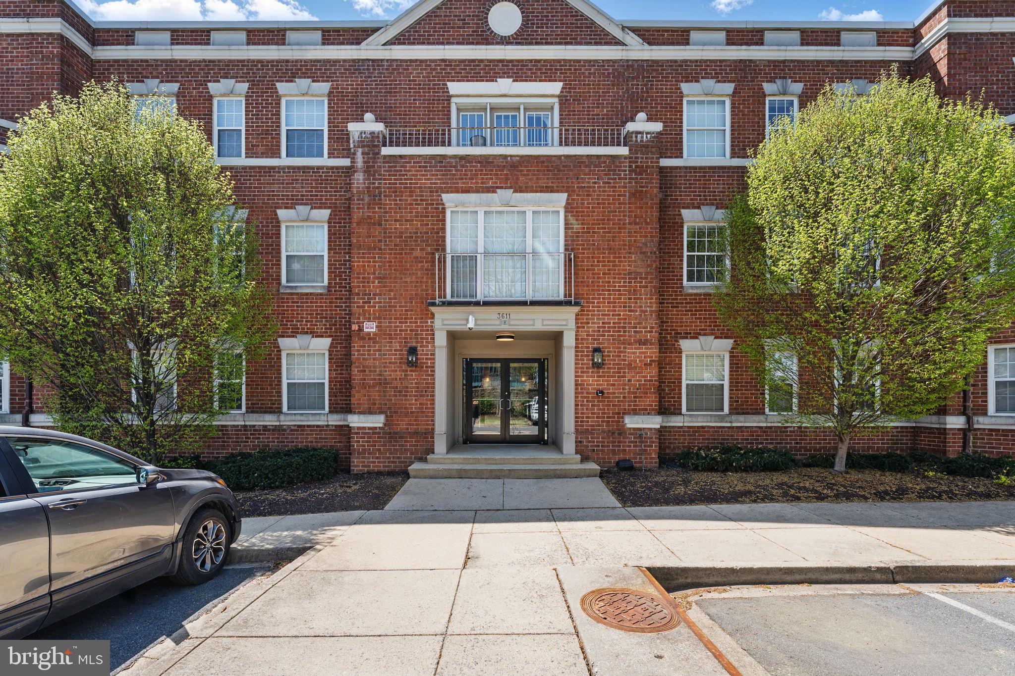 3611 38th Street Northwest, Unit 209 Washington, DC 20016 - Photo 2 of 30 a front view of a house with yard