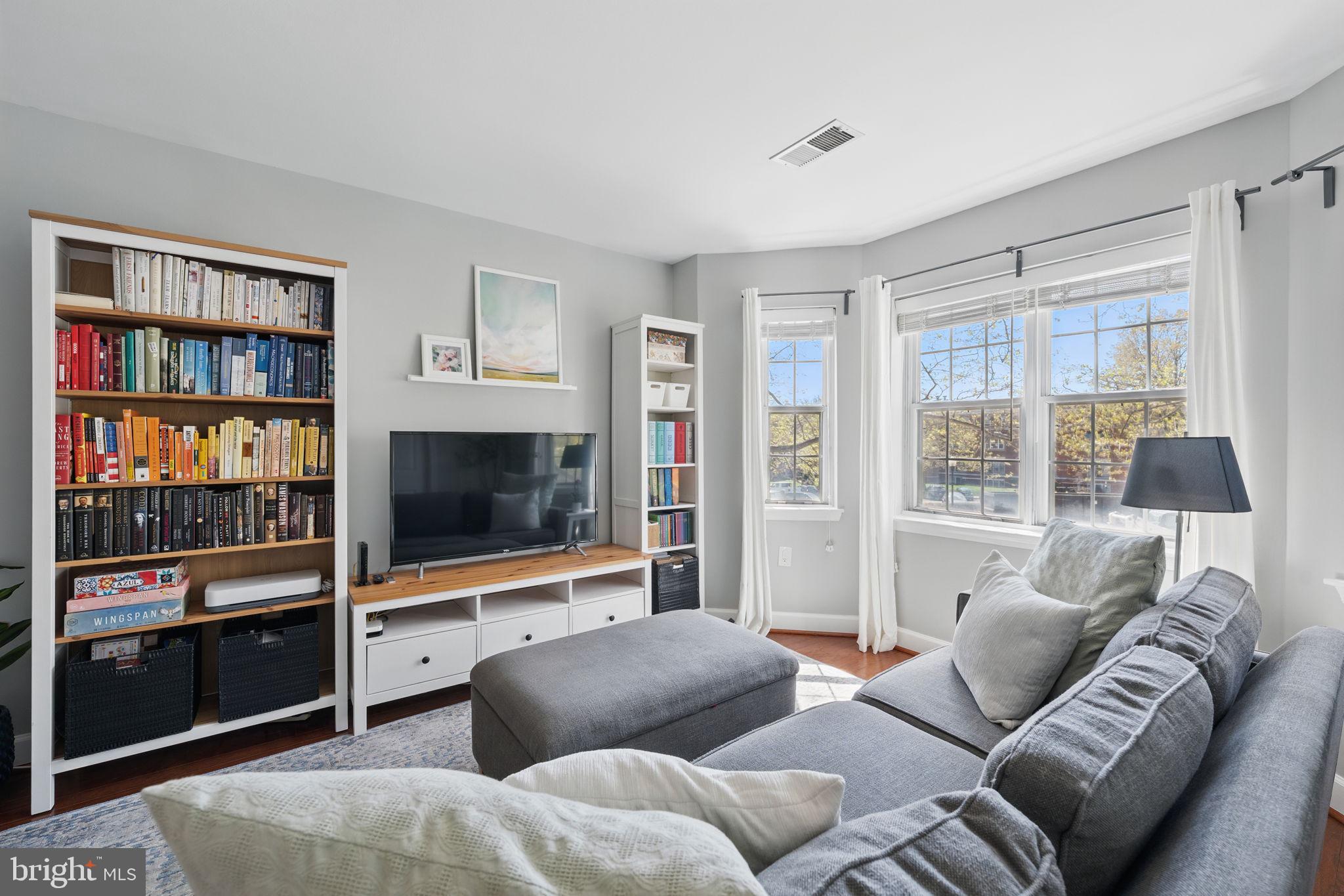 3611 38th Street Northwest, Unit 209 Washington, DC 20016 - Photo 5 of 30 a living room with furniture and a flat screen tv