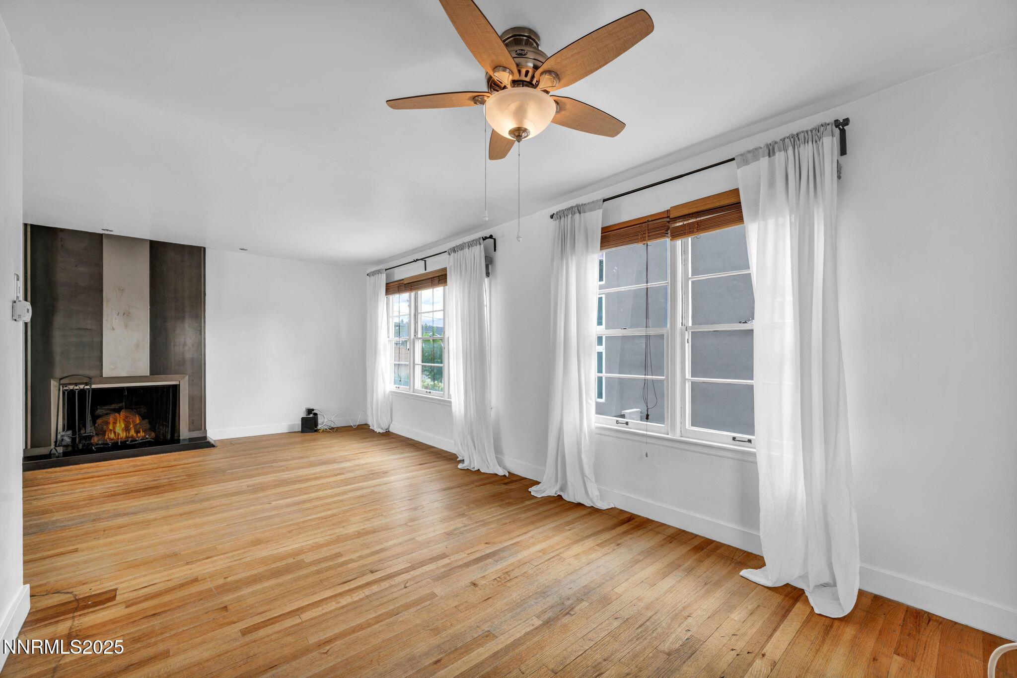 343-347 Mt Rose Street Reno, NV 89509 - Photo 14 of 46 an empty room with fireplace wooden floor and windows