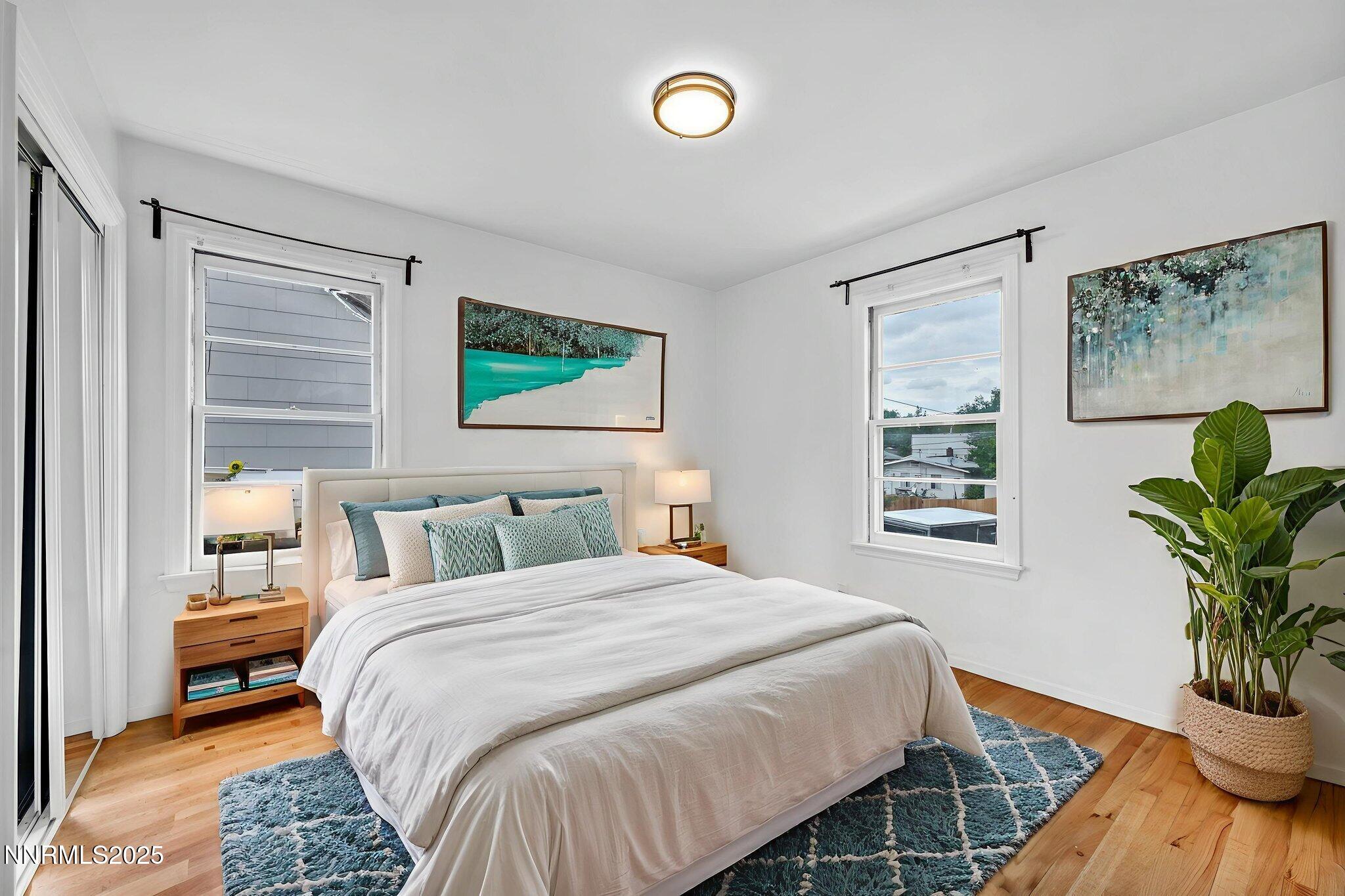 343-347 Mt Rose Street Reno, NV 89509 - Photo 15 of 46 a bedroom with a large bed and a potted plant