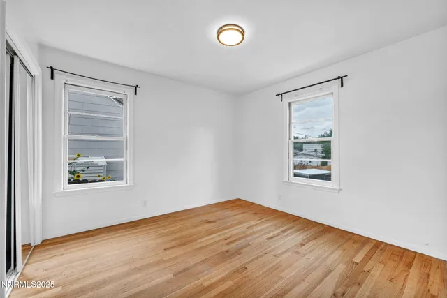 a view of a kitchen with wooden floor and electronic appliances