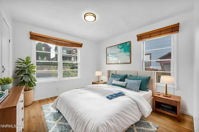 a view of a living room and a large window with wooden floor