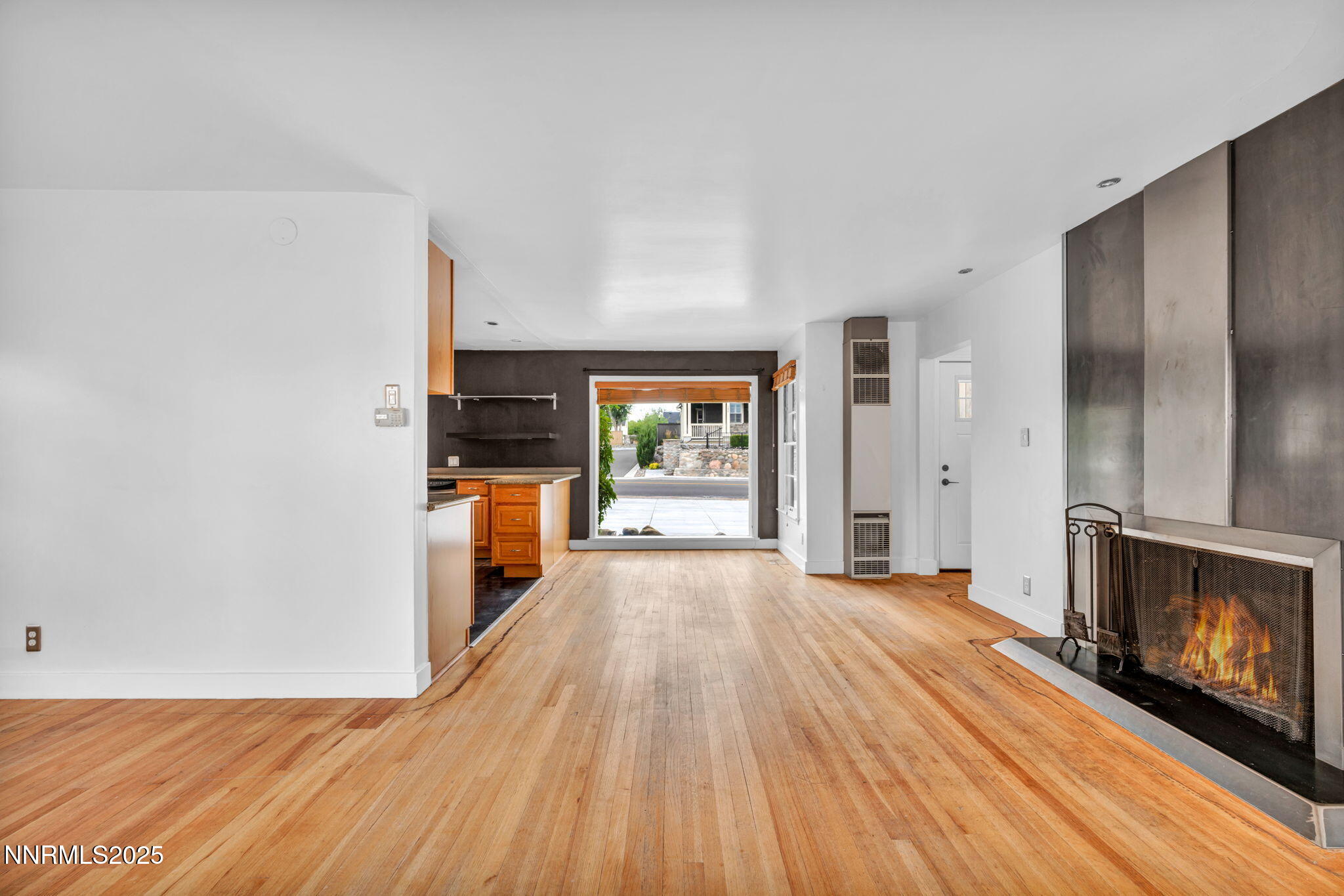 343-347 Mt Rose Street Reno, NV 89509 - Photo 26 of 46 an empty room with wooden floor fireplace and windows