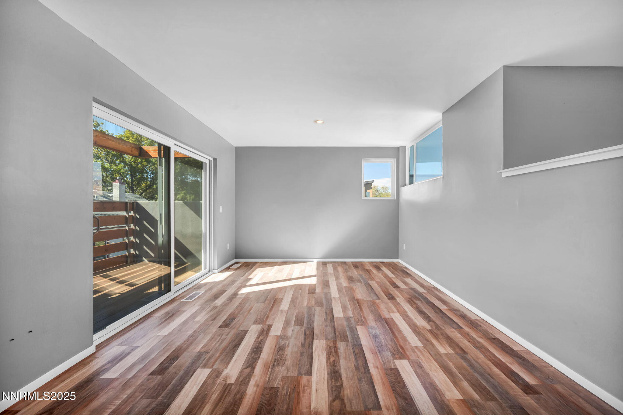 343-347 Mt Rose Street Reno, NV 89509 - Photo 29 of 46 a view of empty room with wooden floor and fan