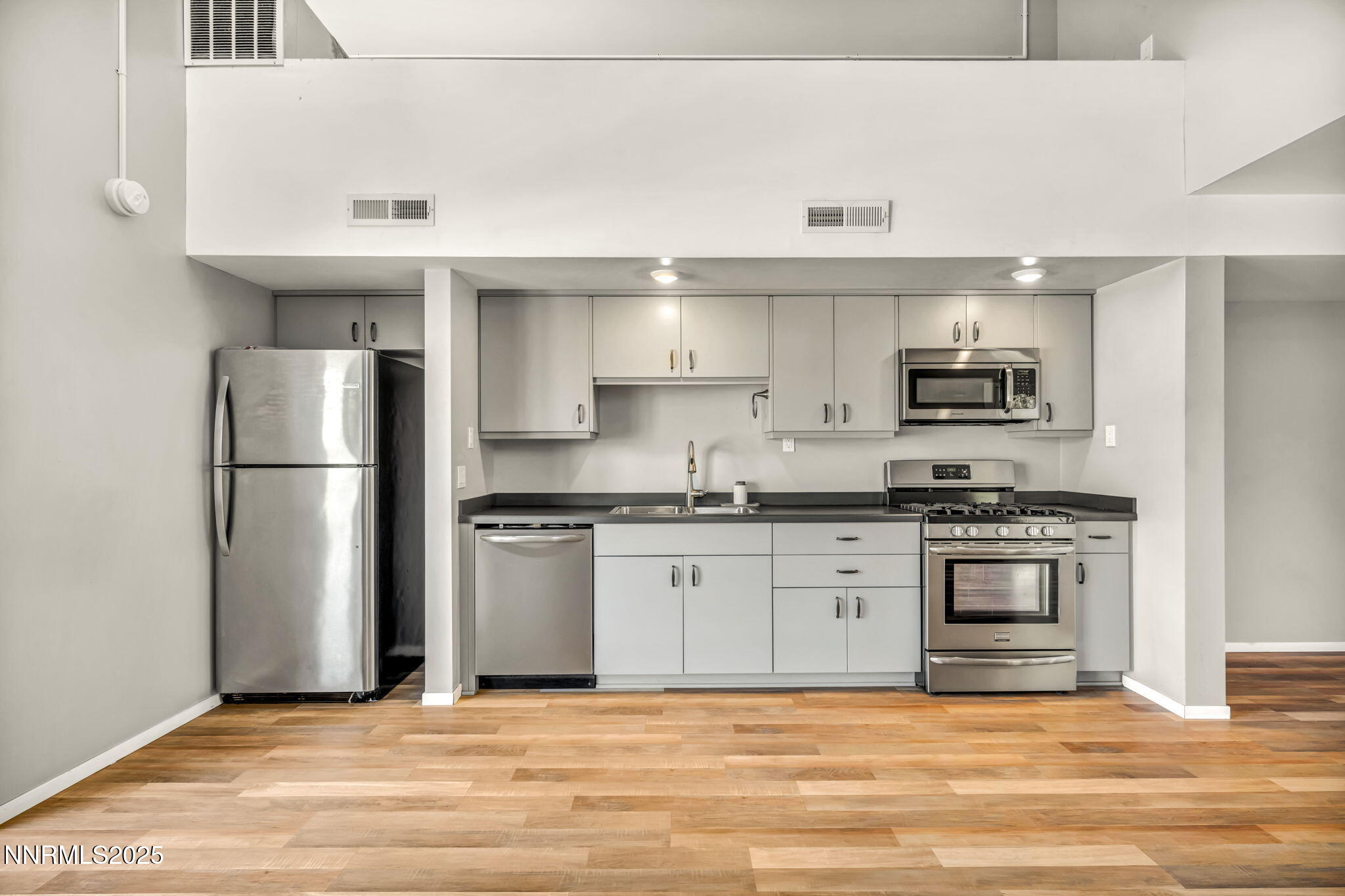 343-347 Mt Rose Street Reno, NV 89509 - Photo 45 of 46 a kitchen with stainless steel appliances granite countertop a refrigerator a stove top oven a sink and dishwasher