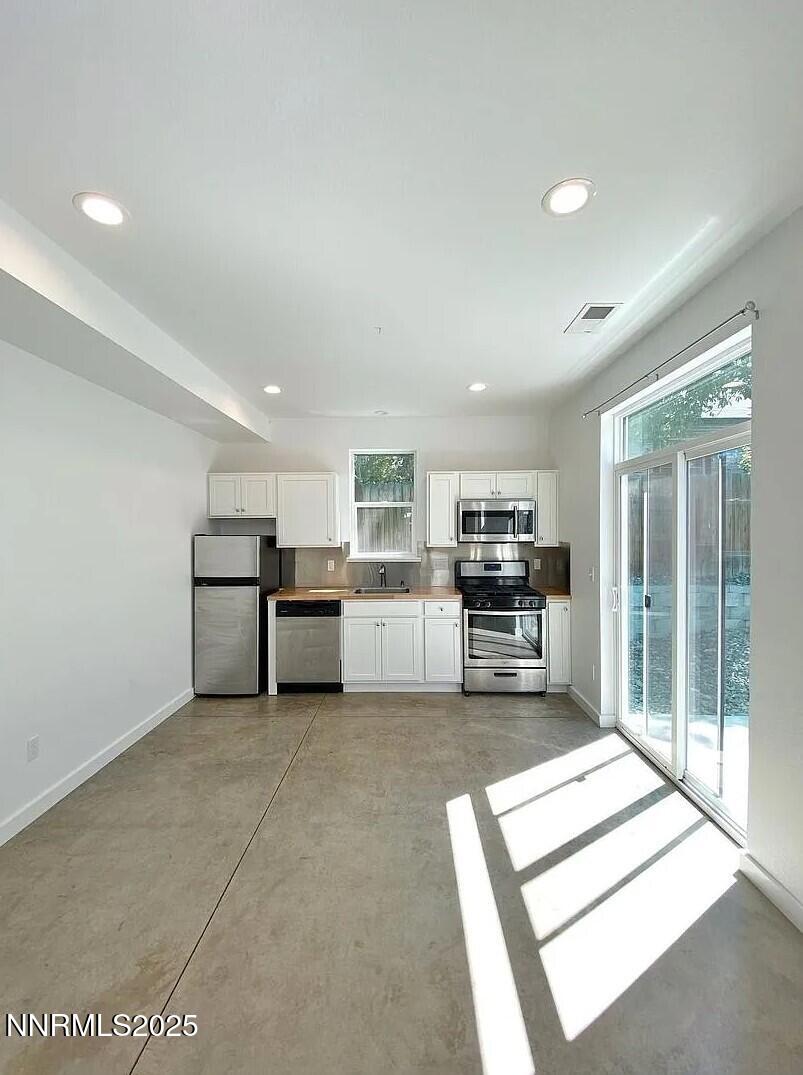446 Roberts Street Reno, NV 89502 - Photo 4 of 14 a view of kitchen with refrigerator and microwave