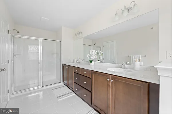 a bathroom with a granite countertop sink mirror and double
