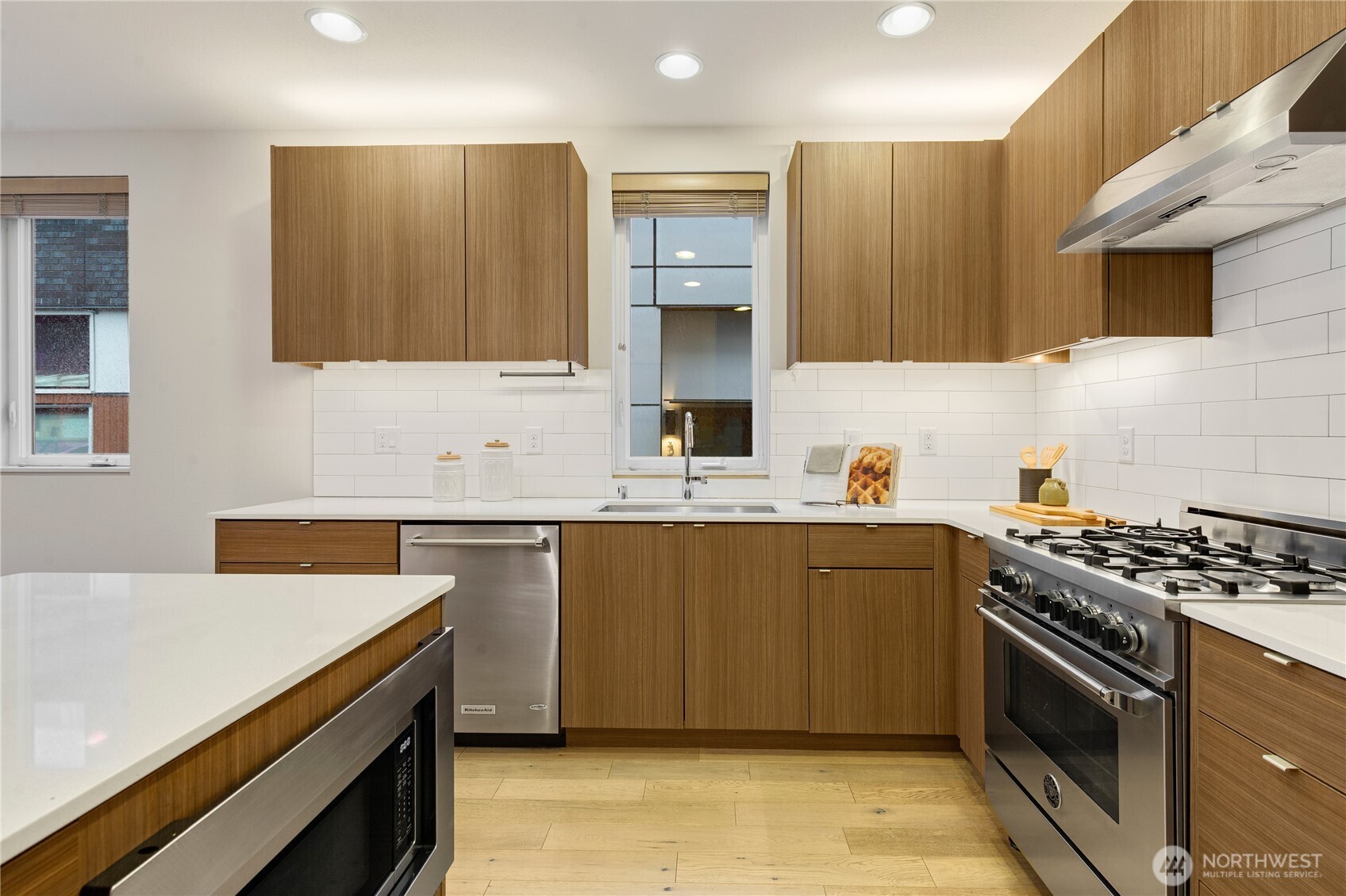 4272 Southwest Bradford Street Seattle, WA 98116 - Photo 11 of 28 a kitchen with a sink stove top oven and cabinets