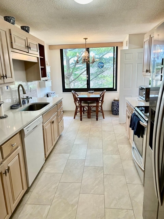 40 Village Road, Unit 309 Middleton, MA 01949 - Photo 2 of 22 a kitchen with stainless steel appliances a sink stove and a window
