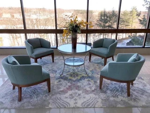 a living room with furniture and a floor to ceiling window
