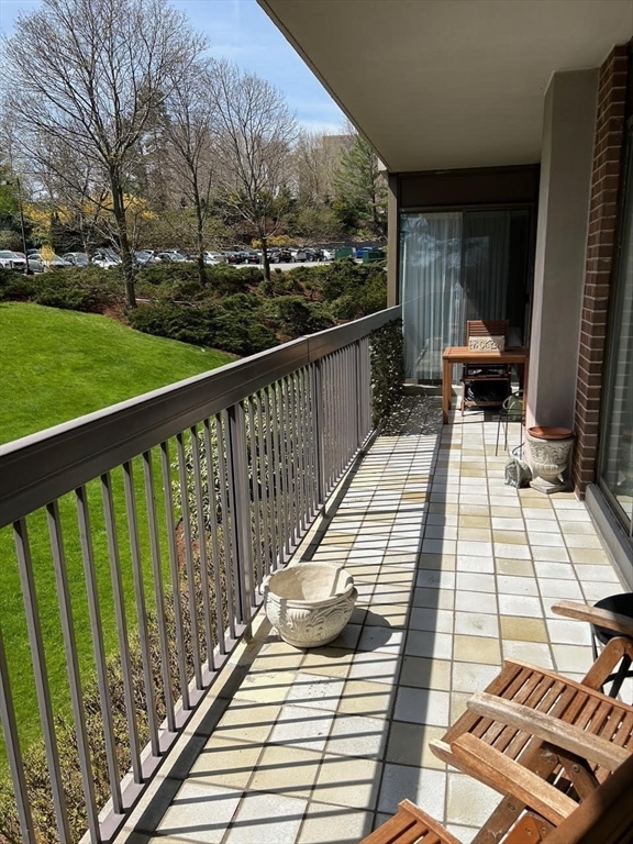40 Village Road, Unit 309 Middleton, MA 01949 - Photo 6 of 22 a view of balcony with wooden floor and fence