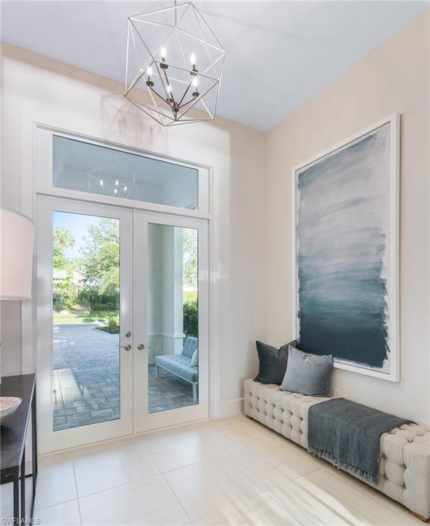 16745 Cabreo Drive Naples, FL 34110 - Photo 2 of 29 a living room with furniture and a chandelier