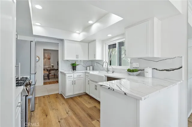a kitchen with sink cabinets and wooden floor