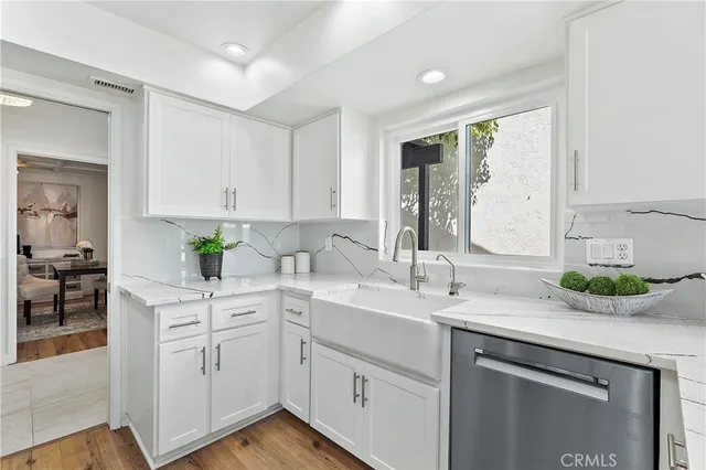 a kitchen with white cabinets and white appliances