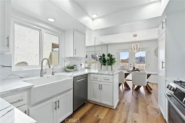 a view of kitchen with sink dining table and chairs