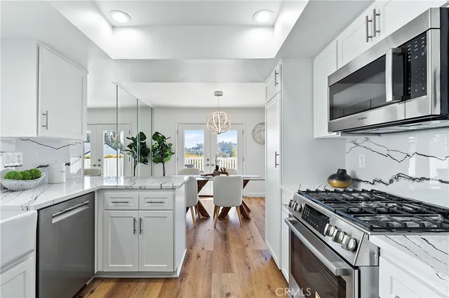 a kitchen with a stove and white cabinets
