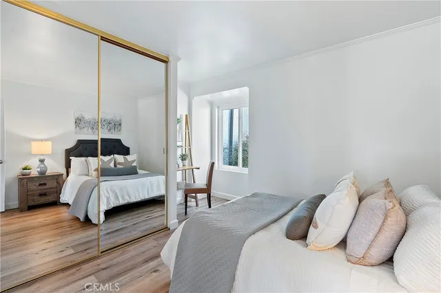 a bedroom with a bed and a large window