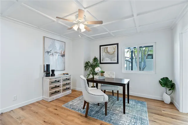 a dining room with furniture potted plants and wooden floor