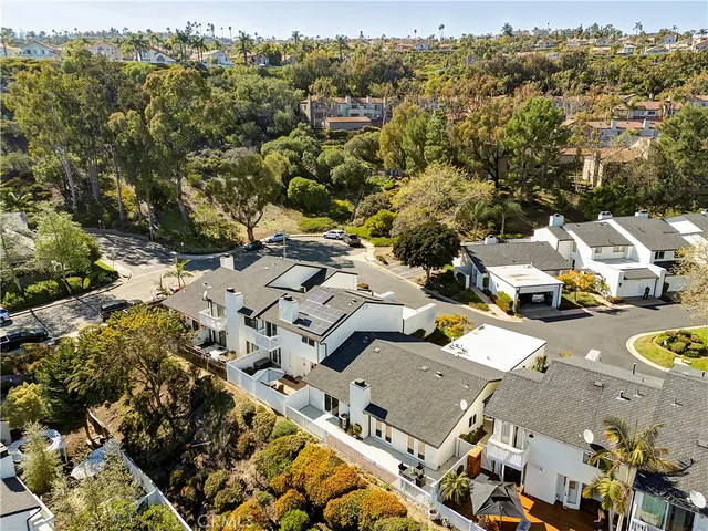 an aerial view of multiple houses with yard